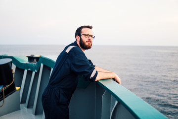 Deck Officer wearing glasses on deck of offshore vessel or ship. Work at sea.