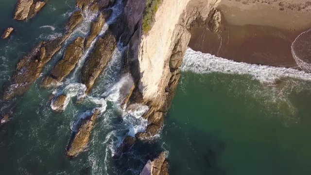 306 Big Sur aerial birds eye view ocean waves hitting the cliffs