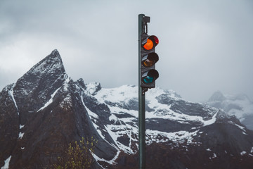 Traffic lights with red turned on the background of snow-capped mountains