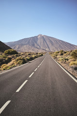Scenic road with Mount Teide in background, color toning applied, Teide National Park, Tenerife, Spain.