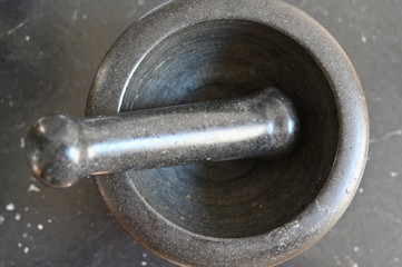 An old black mortar made of stone.