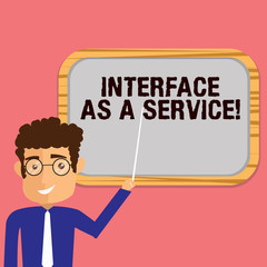 Conceptual hand writing showing Interface As A Service. Business photo showcasing Information technologies assistance support Man Holding Stick Pointing to Wall Mounted Blank Color Board