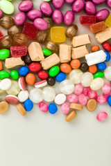 multicolored caramel candies scattered on the table background. sugar products. colored sweets