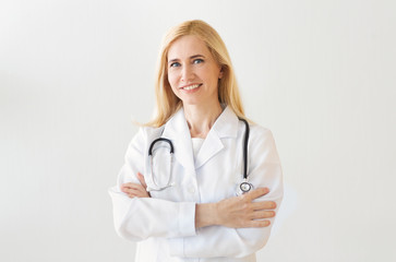Fototapeta premium Happy Doctor With Arms Crossed Over Grey Background