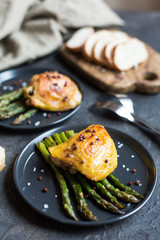 Asparagus with baked chicken thighs.