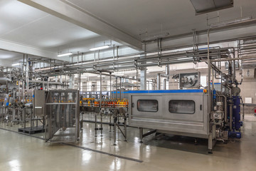 Automatic conveyor belt of production line of juice on beverage plant or factory, modern computerized industrial equipment