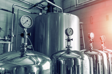 Manometers on steel cylinder storages or vats or tanks on juice and water production plant,...