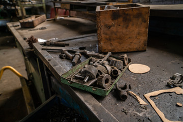 Lots of old tools in factory work desk