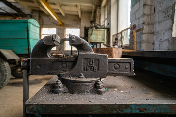 Old russian made vice attached on work desk in old factory