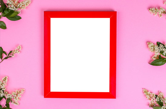 mockup painting in frame on pink background. decorated with flowers