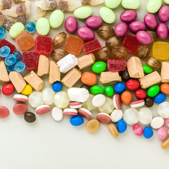 multicolored caramel candies scattered on the table background. sugar products. colored sweets