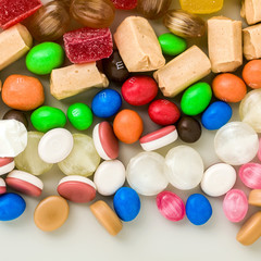 multicolored caramel candies scattered on the table background. sugar products. colored sweets