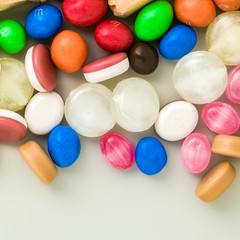 Fototapeta na wymiar multicolored caramel candies scattered on the table background. sugar products. colored sweets