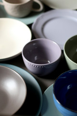 Obraz na płótnie Canvas Collection of pottery and kitchenware in muted pastel colors. Selective focus.