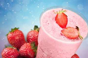 Glass of strawberry smoothie on wooden table