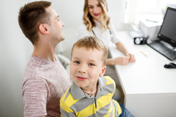The family father and son are examined by a general practitioner. Consultation with a doctor.