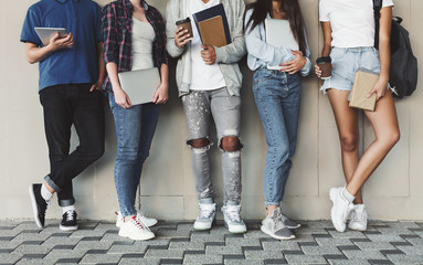 Group of Diverse Teenagers Posing with Gadgets and Books