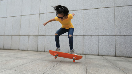 woman skateboarder legs skateboarding at city © lzf