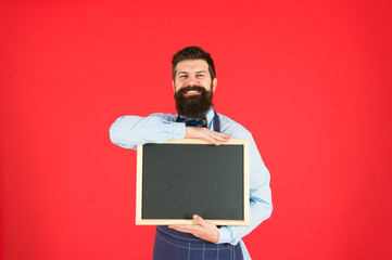 Hiring staff. Hipster bartender show blackboard copy space. Hipster restaurant staff. Hipster informing you. Man bearded bartender or cook in apron hold blank chalkboard. Vacant positions concept