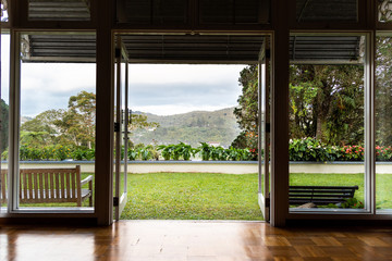 Glass door opening to refreshing, green, nature landscape scenic view