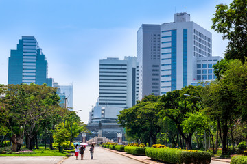 View at Bangkok skyscrapers from Lumpini city park, green oasis in modern busy city