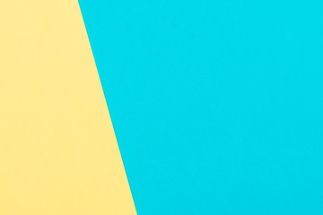 Blue and yellow paper flat composition background with color paper geometry copy space.