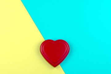 Red heart on yellow and blue background for Valentine day to romantic, love concept and idea for postcard and copy space.