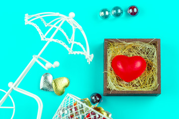 Red heart in wood box with straw and mini bike on blue background for love and Valentine idea  concept to romance.