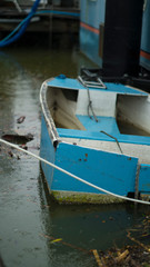Fototapeta na wymiar Small Boat Slowly Sinking After Storm Damage