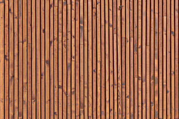 Smooth dark brown boards with knots. Background of wood slats. The texture of the wooden surface of the slats. - obrazy, fototapety, plakaty