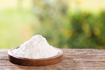 Baking soda, Sodium bicarbonate. Wooden table in the park among the trees on a summer day. Text space