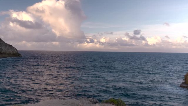 The remarkable view from Trou de Madame Coco in Guadeloupe showing an immense coastline bundled with blue water at sunset