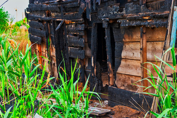 Old house made of wood half burnt