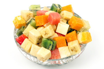 assorted fruit chopped in cubes on a plate on white background