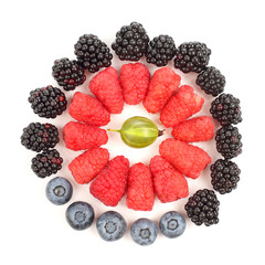 raspberries, blackberries, blueberries laid out in the shape of circle
