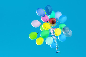 multicolored balloons flying in the blue sky