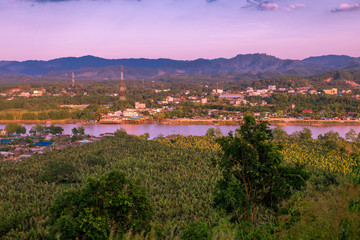 Fototapeta premium High mountain view background, able to see the surrounding natural atmosphere (communities on the waterfront, trees, water, sky) and wind blowing through the cool. 