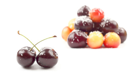 cherries sprinkled with coconut on white background