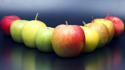 fresh different apples on dark background © photosaint