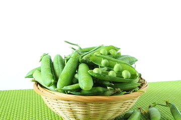 fresh open green pea pods and green peas isolated on the white background