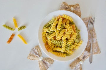 Tasty colourful mac & cheese macaroni in the white bowl