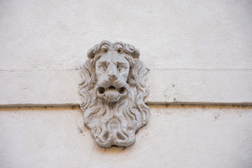 head of a lion, on a building in Verona, Italy, 2019
