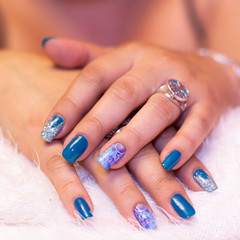 Manicure nails blue color on white background