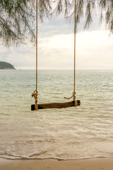 Wooden swing on a tropical beach, close up