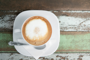  hot cup with saucer on  wooden background.top view.right copy space.