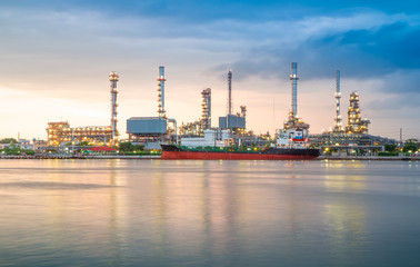 Naklejka premium Oil refinery or petrochemical industry with ship in thailand. for Logistic Import Export background,Chao Phraya river, Thailand