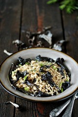 black chanterelle risotto. Black Trumpet mushrooms recipe. Italian food. place for text. copy space.