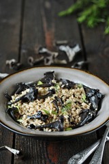 black chanterelle risotto. Black Trumpet mushrooms recipe. Italian food. place for text. copy space.