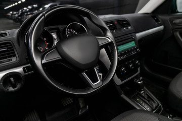 Close-up of the dashboard, speedometer, tachometer and steering wheel, dashboard. Luxurious car...