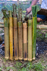Burning bamboo rice in traditional cooking, asian food. Ubud, island Bali, Indonesia . Closeup. Burned sticky rice with sweet coconut milk in bamboo shot